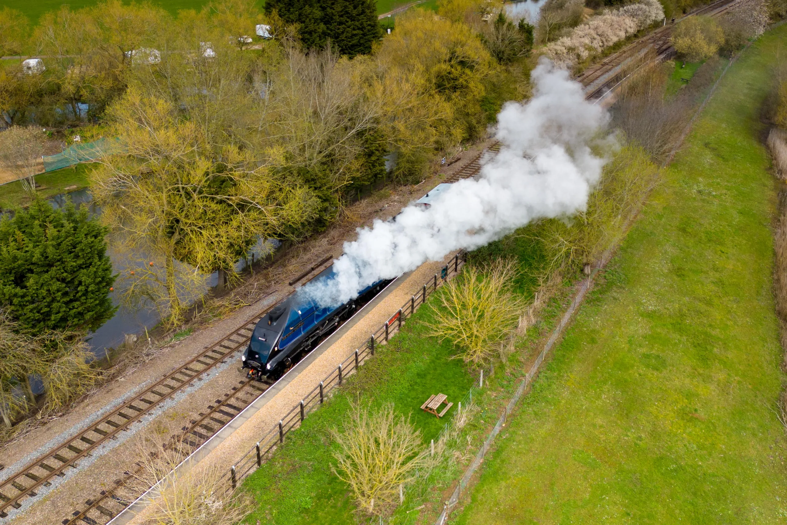 LNER Class A4 4498 Sir Nigel Gresley..
N°4498 Sir Nigel Gresley was the 100th Gresley Pacific built by the Great Northern Railway / London and North Eastern Railway. Built at Doncaster as works N°1863, the locomotive entered service in 1937 following a naming ceremony at Marylebone station on 26th November. The locomotive was mainly based at London King's Cross, with a spell at Grantham during World War II, and was briefly re-numbered as N°7 before becoming N°60007 when the LNER was merged into British Railways. On 3rd June 1956 Sir Nigel Gresley had the honour of hauling the Royal Train from King's Cross to York with H.M the Queen on board. The "Stephenson Locomotive Society Special" of the 23rd May 1959 was the first train in the UK with a booked or advertised schedule of over 100 m.p.h. and during that trip N°60007 set the official post-war speed record for steam traction of 112 mph.
Wansdford, Peterborough
Thursday 06 April 2023.
Picture by Terry Harris.