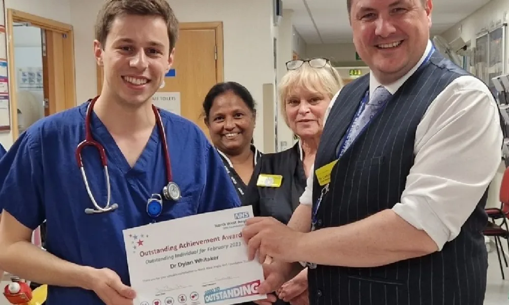 North West Anglia NHS Foundation Trust Chief Medical Officer, Dr Callum Gardner presents Dr Dylan Whitaker (left) with his Outstanding Individual of the Month certificate.