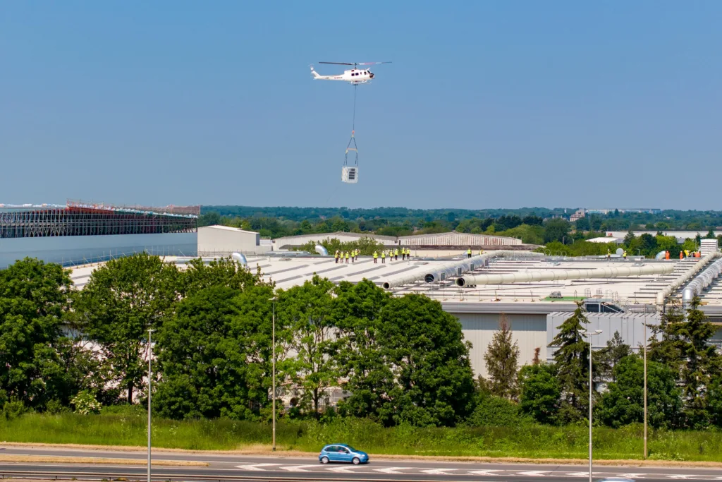 A 625,000ft sq ft factory complex under construction in Peterborough is using a Bell 205A-1 Helicopter (Helilift Services) to move construction materials to the roof of the massive factory.,Delta Park, Peterborough
Saturday 10 June 2023. 
Picture by Terry Harris.