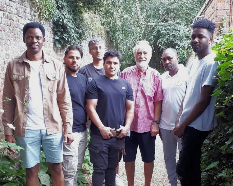 Pictured above is Sean Finlay with his Wisbech guests at Peckover House. Mr Finlay and his friends took a party of asylum seekers currently being housed at Rose and Crown Hotel out for a visit to the National Trust property.