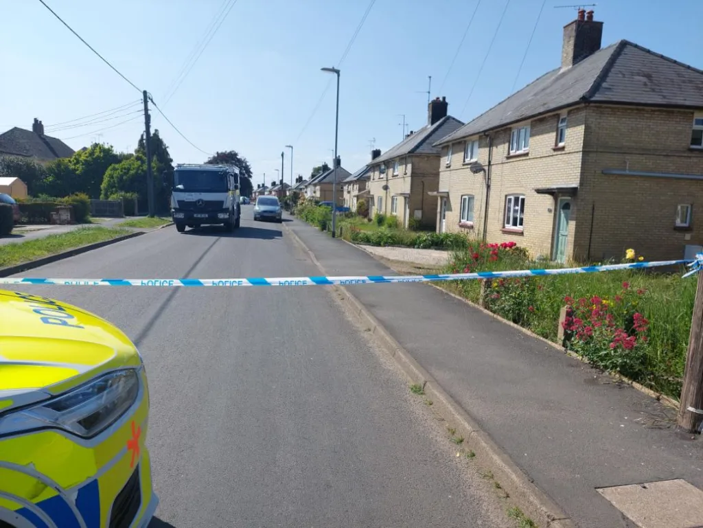 Convicted paedophile Paul Page (inset) and the police cordon in May in Parson’s Lane, Littleport.