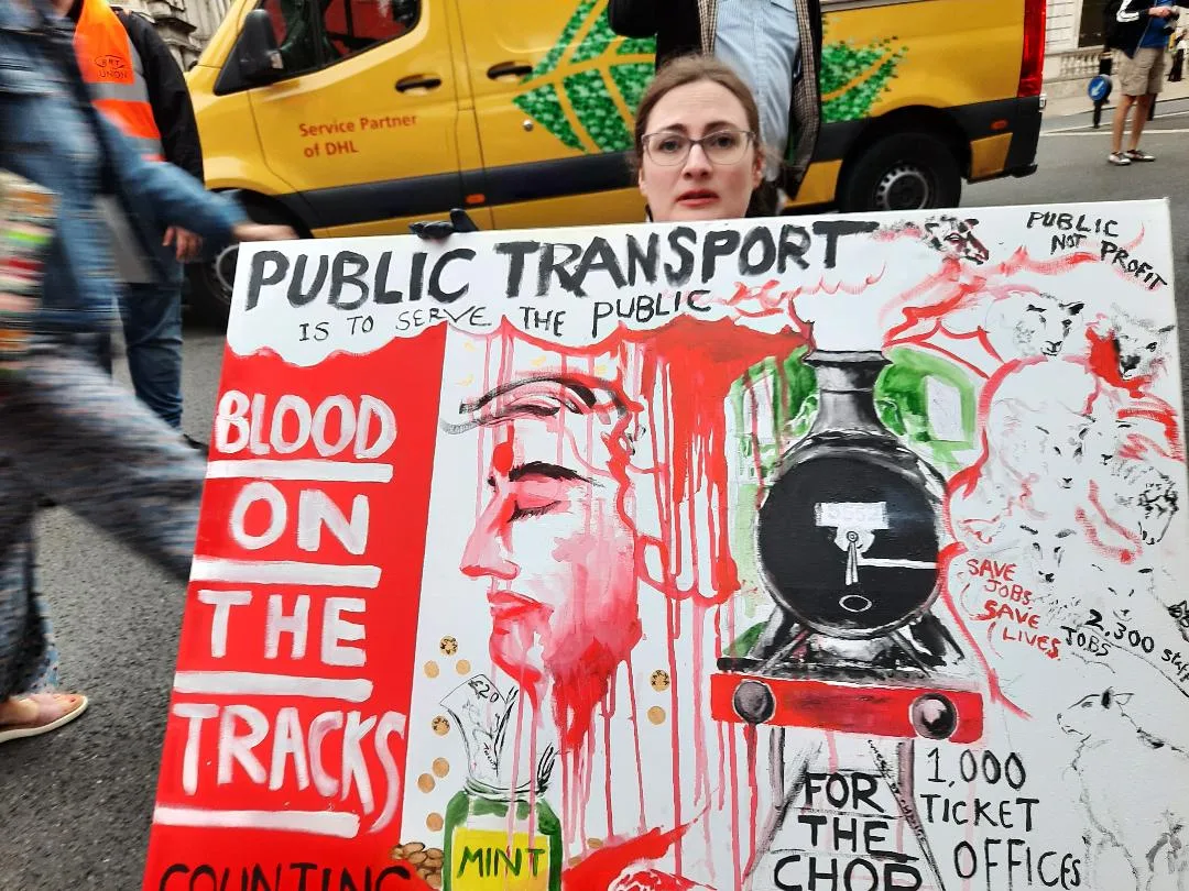Blood on the line - a protestor in a wheelchair with her placard. On Thursday, an estimated 1,000 people – one for every ticket office facing closure - marched for the cause.