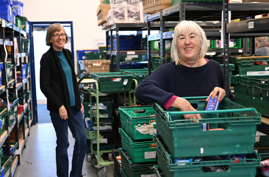 Cambridge City Foodbank volunteers sorting and packing donations at the Foodbank warehouse.