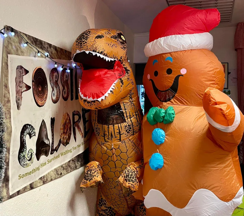 These two – a dinosaur and Gingerbread person – found the tree hilarious as they walked around March Town tonight during the Christmas Light switch on. PHOTO: Fossils Galore