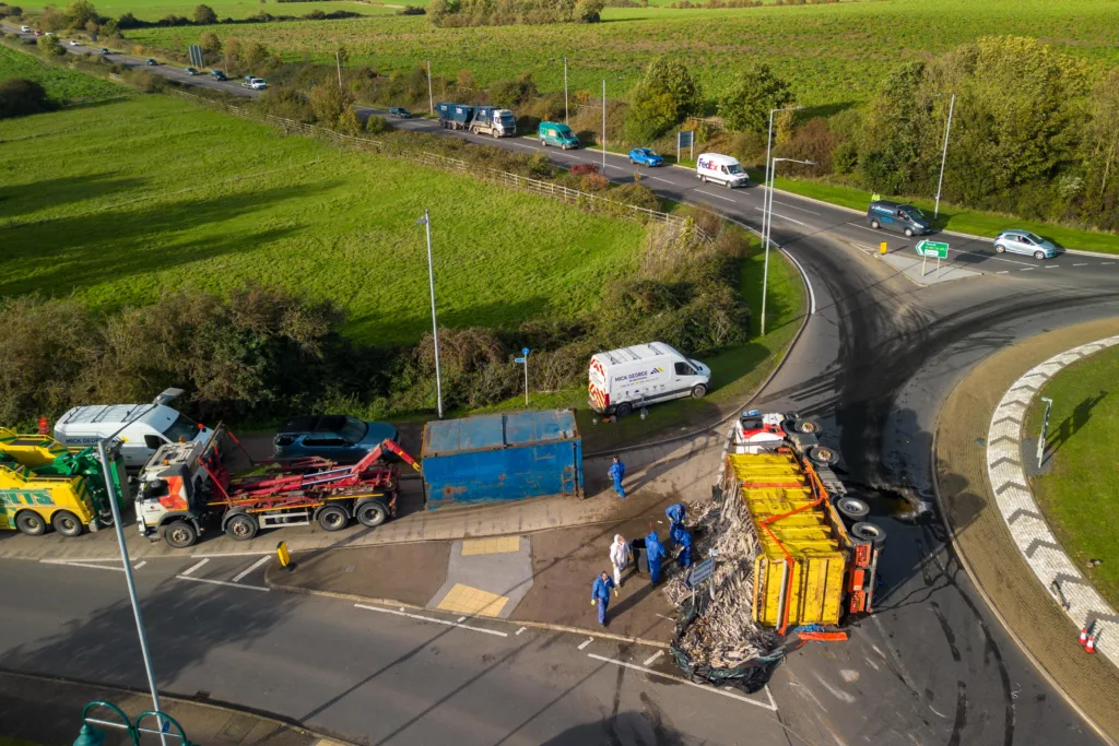 The scene at Witchford roundabout today as recovery takes place of the contents of a lorry that shed its load. PHOTO: Terry Harris for CambsNews
