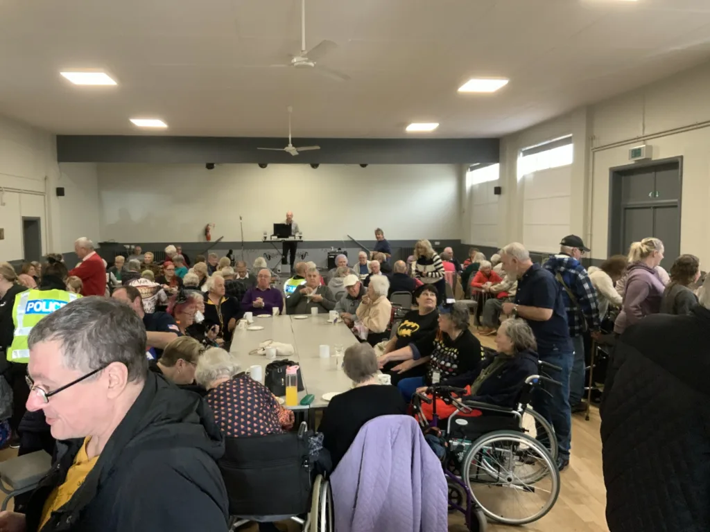 High Sheriff of Cambridgeshire, Dr Bharatkumar Khetani, cut the birthday cake as Walsoken Village Hall Community Coffee Morning celebrated its 2nd anniversary. Local police dropped in for a cuppa and cake. PHOTO: Wisbech Tweet 
