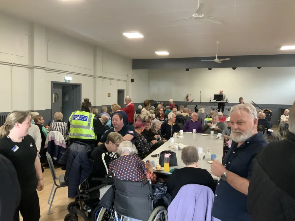 High Sheriff of Cambridgeshire, Dr Bharatkumar Khetani, cut the birthday cake as Walsoken Village Hall Community Coffee Morning celebrated its 2nd anniversary. Local police dropped in for a cuppa and cake. PHOTO: Wisbech Tweet 
