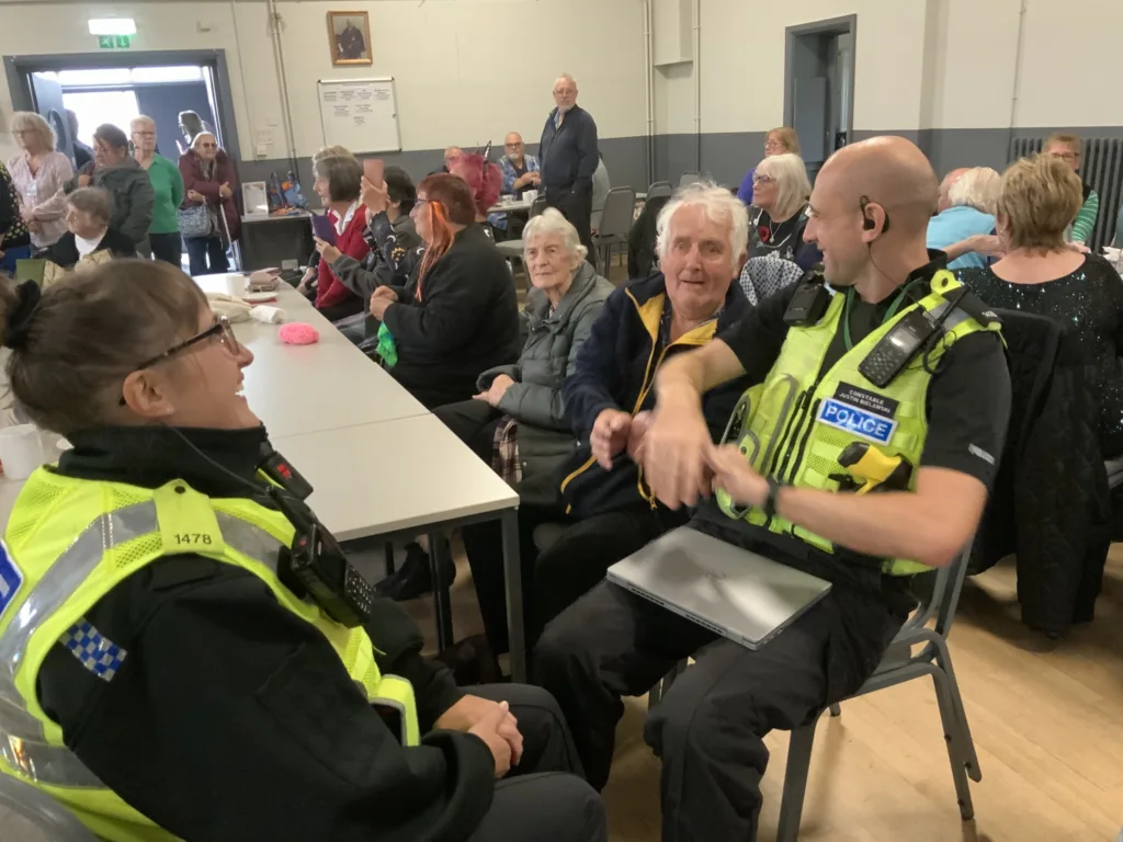 High Sheriff of Cambridgeshire, Dr Bharatkumar Khetani, cut the birthday cake as Walsoken Village Hall Community Coffee Morning celebrated its 2nd anniversary. Local police dropped in for a cuppa and cake. PHOTO: Wisbech Tweet 
