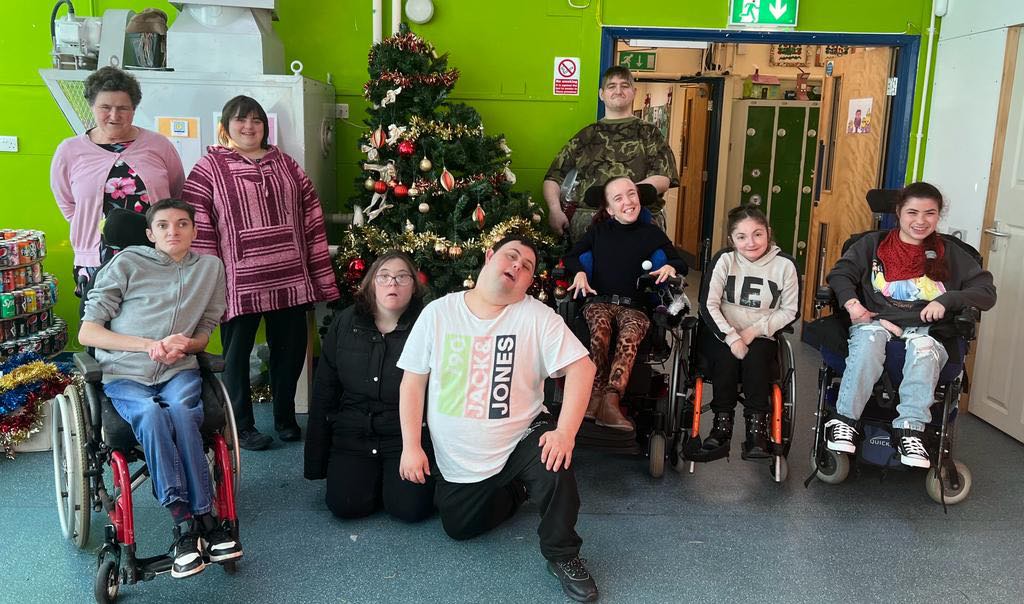 FACET students all smiles as they show off their own wonky Christmas tree