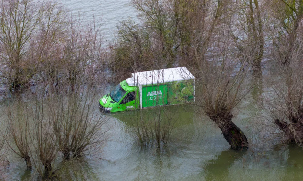 Morning after the night before: The Asda delivery van submerged in water midway through the Welney Wash Road on the A1101 bordering Cambridgeshire and Norfolk. PHOTO: Bav Media