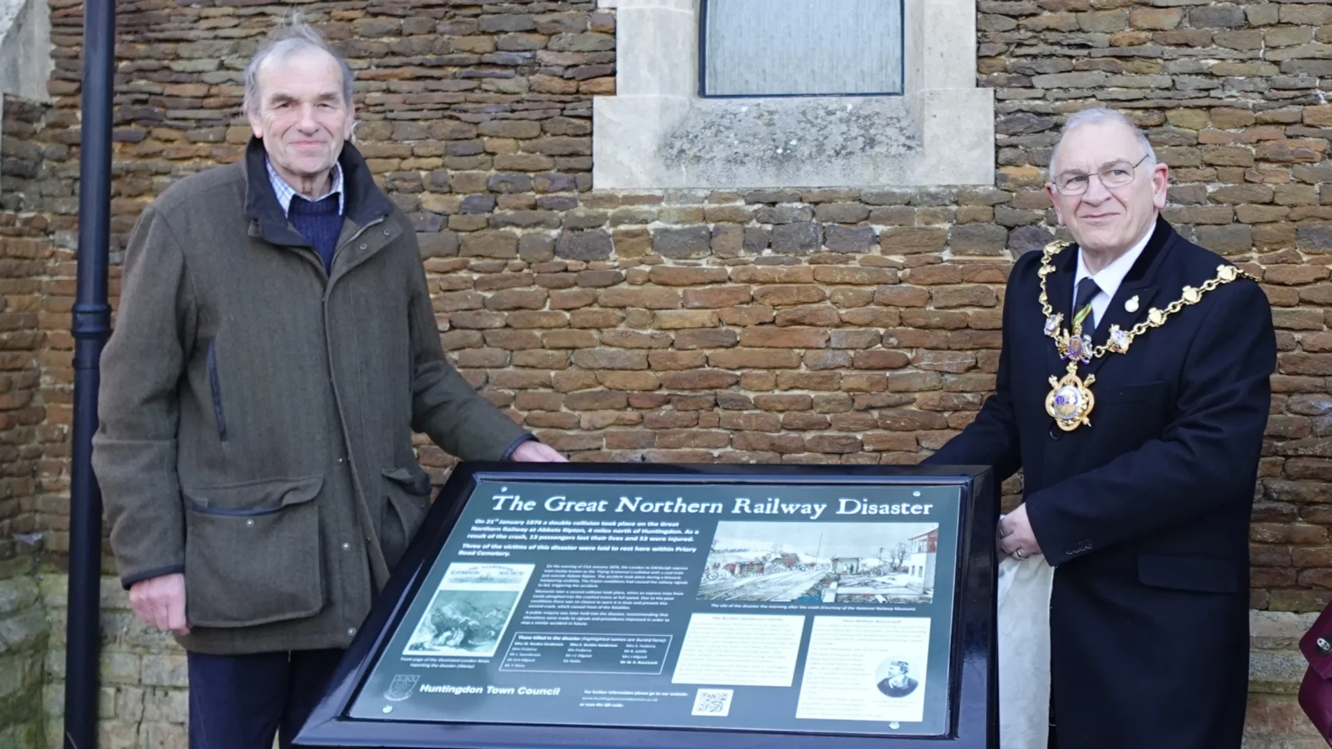 3. Mayor of Huntingdon Phil Pearce and Charles Saunders next to the interpretation Board (002) - News for Peterborough and Cambridgeshire News for Peterborough and Cambridgeshire - The newly installed interpretation board was unveiled by Cllr Phil Pearce, Mayor of Huntingdon, and Charles Saunders, who recently restored the grave of victim Dion William Boucicault.