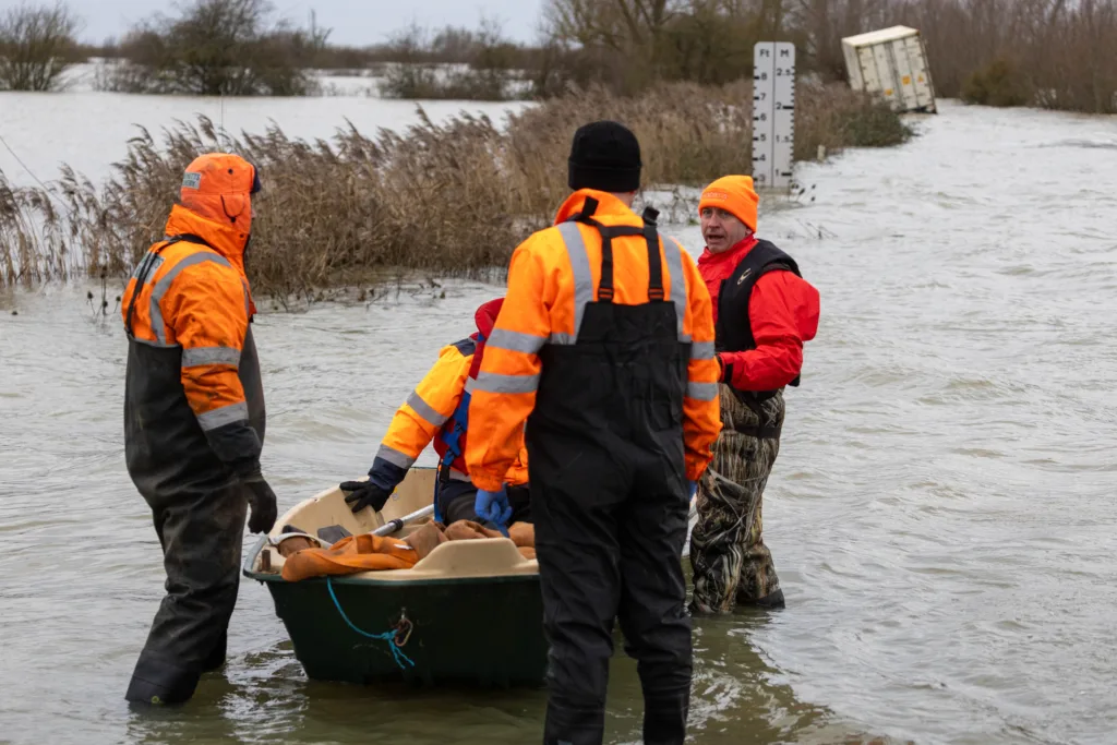 Manchetts staff weighing up the options to rescue lorry and container from flooded A1101 at Welney on the Cambridgeshire/Norfolk border. PHOTO: Terry Harris 