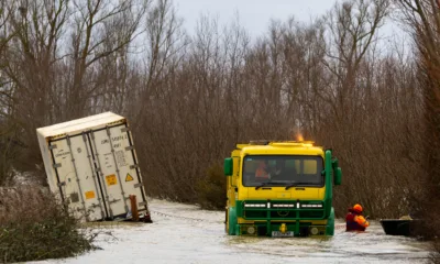 Manchetts staff weighing up the options to rescue lorry and container from flooded A1101 at Welney on the Cambridgeshire/Norfolk border. PHOTO: Terry Harris