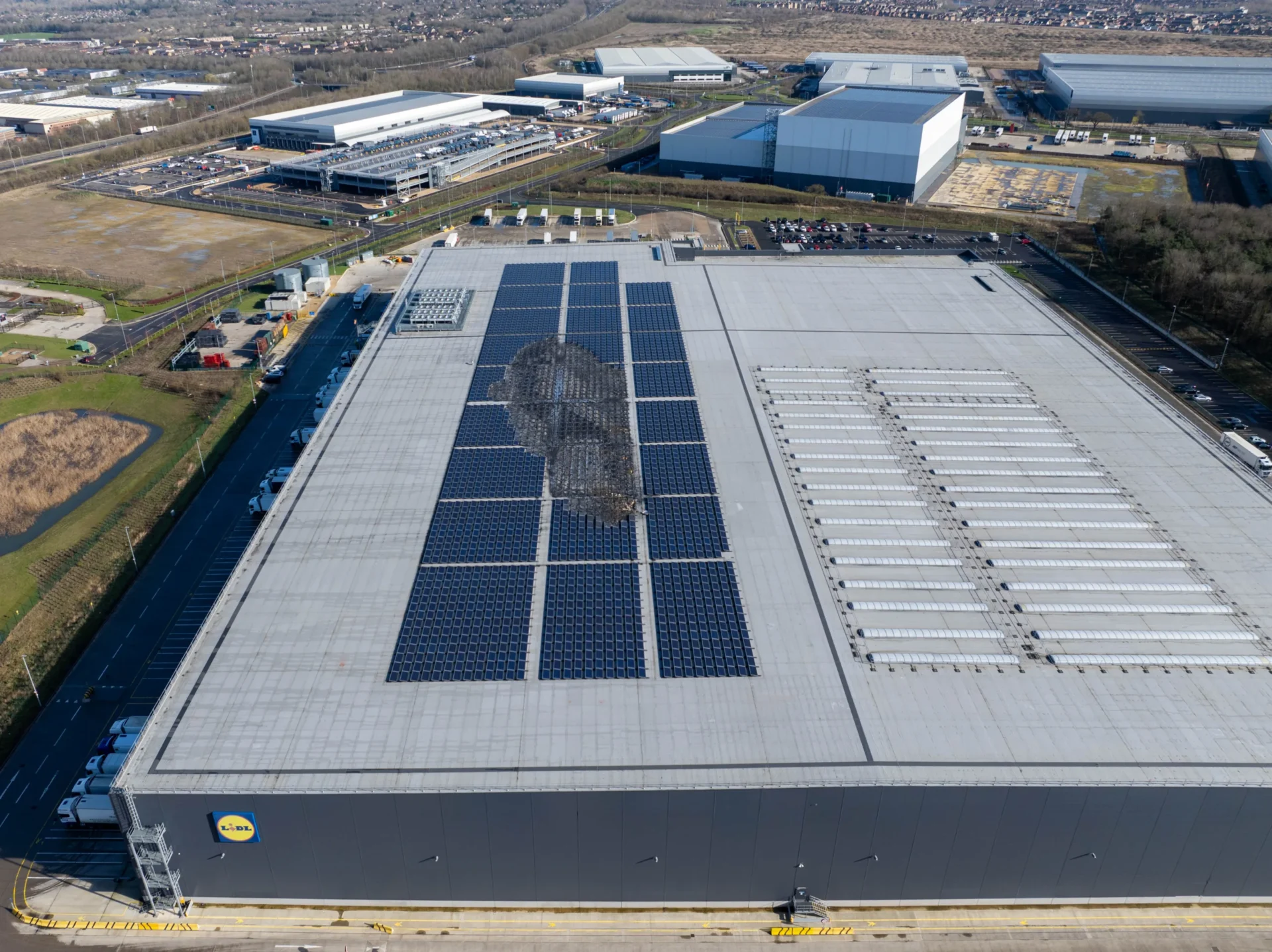 £70mil Lidl RDC (Regional Distribution Centre)Warehouse Damaged Solar Panels. - News for Peterborough and Cambridgeshire News for Peterborough and Cambridgeshire - It was back to business shortly afterwards for Lidl distribution centre in Peterborough after solar panels caught fire. 11 fire engines and around 40 firefighters, as well as a water carrier and an aerial appliance, were quickly on the scene. PHOTO: Terry Harris