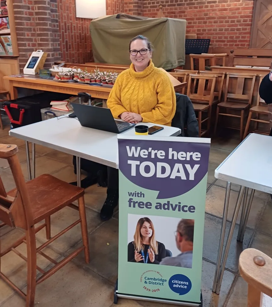 An advisor from Cambridge and District Citizens Advice inside a Cambridge City Foodbank welcome centre