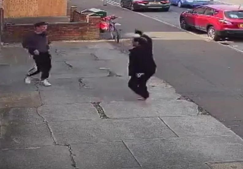 Shortly after being attacked and robbed, a brave shopworker is seen hitting back at her attacker outside her shop. IMAGE: Cambs Police