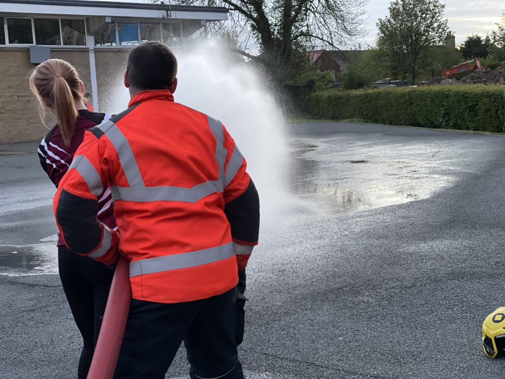 The women’s team of March Bears Rugby Club learn some basic fire fighter techniques during a visit to March Fire Station. PHOTO: Cambs Fire and Rescue