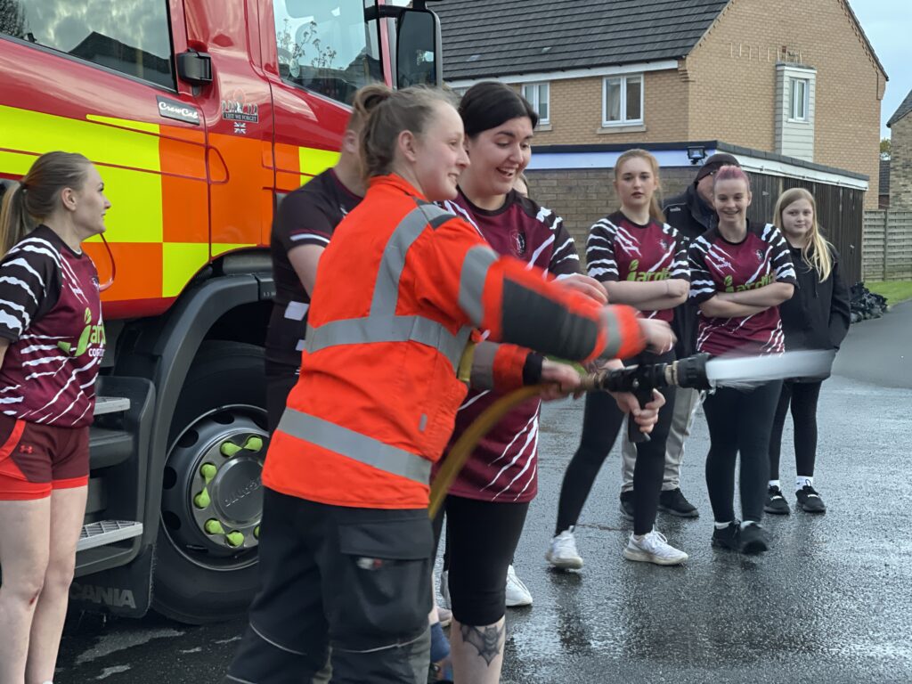 The women’s team of March Bears Rugby Club learn some basic fire fighter techniques during a visit to March Fire Station. PHOTO: Cambs Fire and Rescue