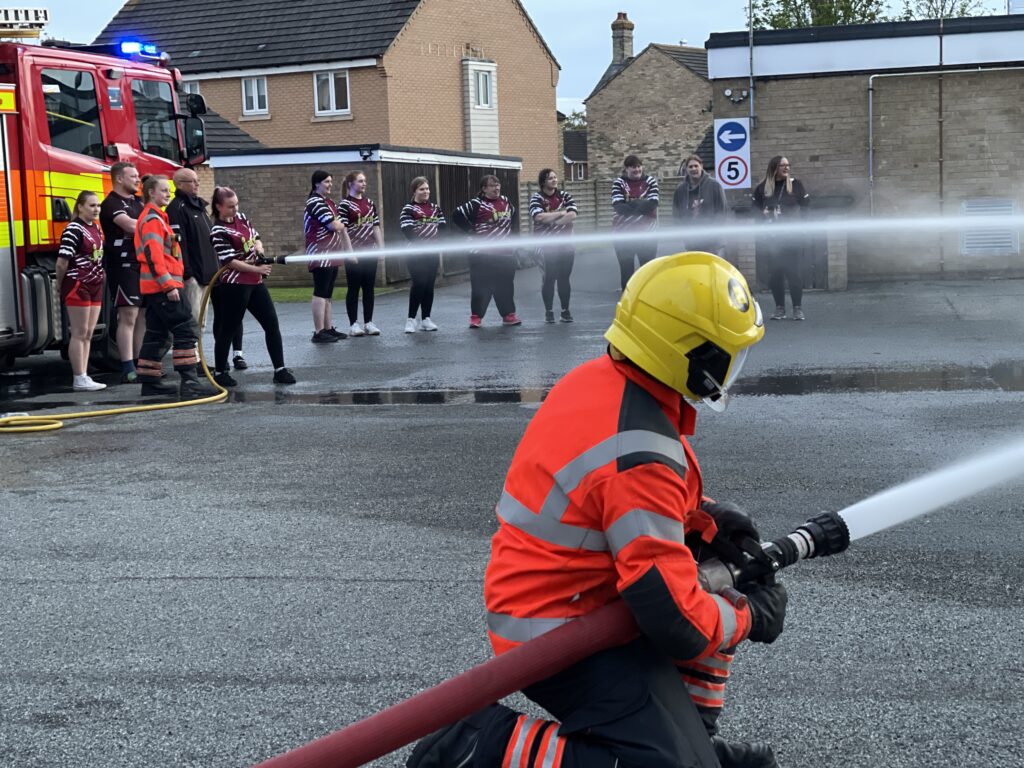 The women’s team of March Bears Rugby Club learn some basic fire fighter techniques during a visit to March Fire Station. PHOTO: Cambs Fire and Rescue