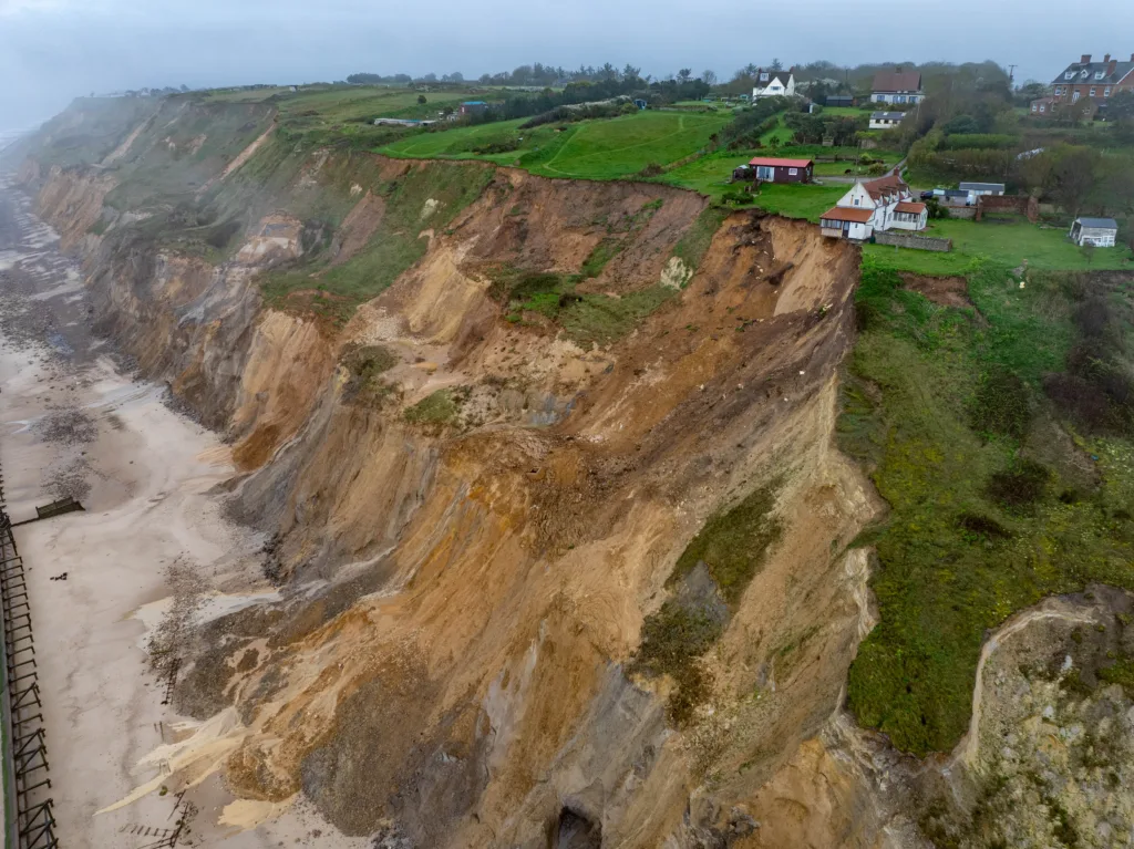 Shocking photos taken today (Thurs) show a three-bedroom house hanging perilously over a cliff edge on the north Norfolk coast after a surge of recent cliff falls., Trimingham, Norwich Thursday 04 April 2024. Picture by Terry Harris