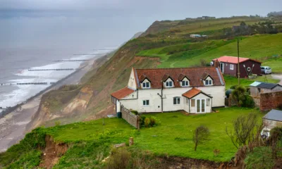 Shocking photos taken today (Thurs) show a three-bedroom house hanging perilously over a cliff edge on the north Norfolk coast after a surge of recent cliff falls. , Trimingham, Norwich Thursday 04 April 2024. Picture by Terry Harris