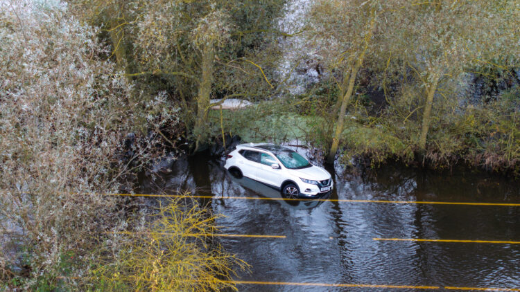 Driver rescued stuck in flood Cambs - News for Peterborough and Cambridgeshire News for Peterborough and Cambridgeshire - Picture dated October 10th shows the abandoned car on the flooded A1101 in Welney on the Norfolk/Cambs border with the driver having to be rescued on Wednesday evening by the fire service. PHOTO: Bav Media
