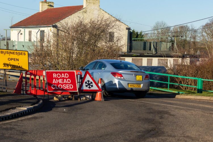 News for Peterborough and Cambridgeshire - Fed up motorists are using local knowledge – some say commonsense – to continue to use the North Bank road near Whittlesey despite closure measures put in place because of flooding. PHOTO: CambsNews