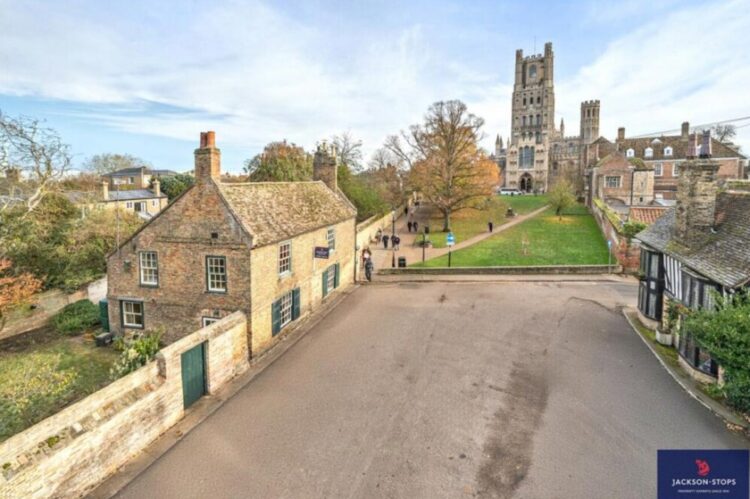 js - News for Peterborough and Cambridgeshire News for Peterborough and Cambridgeshire - An estate agent has REMOVED a photo from a listing for a Grade II listed house overlooking majestic Ely Cathedral in Cambridgeshire – after admitting it ALTERED the picture to delete the parking bays in front of the cottage. PHOTO: BavMedia