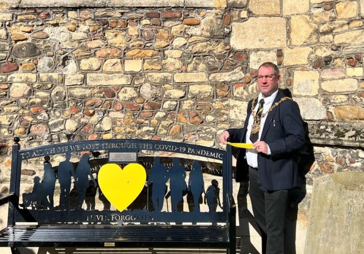 News for Peterborough and Cambridgeshire - Mayor of Huntingdon Cllr Karl Brockett tying a ribbon around the bench