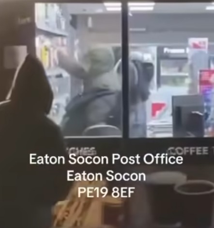 “Look at these lots, robbing post office, getting everything taking all the alcohol and lot” says an onlooker as he filmed outside Eaton Socon post office and Premier store, Eaton Socon, Cambridgeshire. His video has been seen 12,000 times on Facebook.