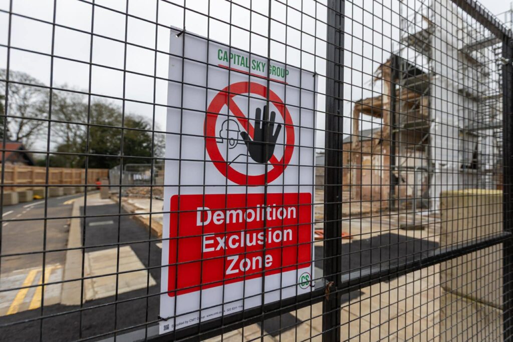 Exclusive CambsNews photos show the aftermath of demolition of the former Barclays Bank in March: a vast, fenced-off hole on Broad Street, next to the war memorial, where a landmark building once stood. PHOTO: Terry Harris