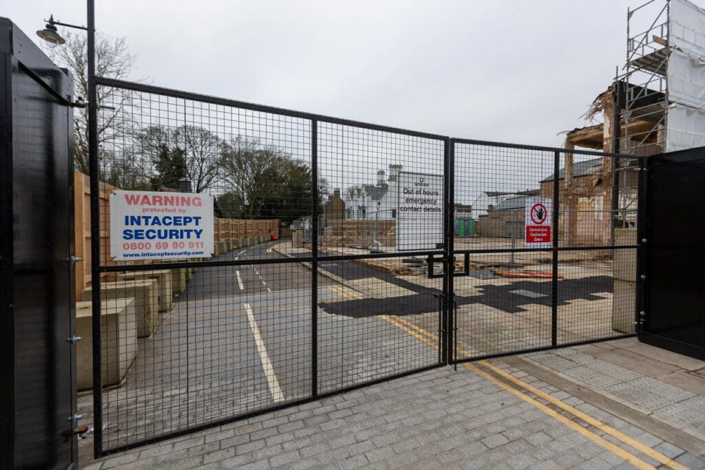 Exclusive CambsNews photos show the aftermath of demolition of the former Barclays Bank in March: a vast, fenced-off hole on Broad Street, next to the war memorial, where a landmark building once stood. PHOTO: Terry Harris