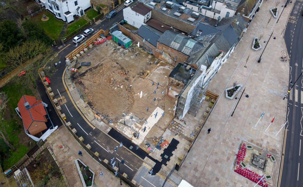 Exclusive CambsNews photos show the aftermath of demolition of the former Barclays Bank in March: a vast, fenced-off hole on Broad Street, next to the war memorial, where a landmark building once stood. PHOTO: Terry Harris