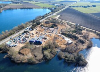Aerial view of Lake View Bereavement Centre under construction in March 2026, showing the emerging butterfly-shaped chapel, landscaped grounds, and preserved natural features. IMAGE: East Cambridgeshire District Council