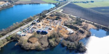 Aerial view of Lake View Bereavement Centre under construction in March 2026, showing the emerging butterfly-shaped chapel, landscaped grounds, and preserved natural features. IMAGE: East Cambridgeshire District Council
