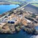 Aerial view of Lake View Bereavement Centre under construction in March 2026, showing the emerging butterfly-shaped chapel, landscaped grounds, and preserved natural features. IMAGE: East Cambridgeshire District Council
