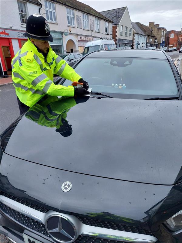 Police officers issue parking tickets during a targeted enforcement operation in Ely, highlighting the continued reliance on limited police resources in the absence of civil parking enforcement across East Cambridgeshire. PHOTO: Policing East Cambridgeshire