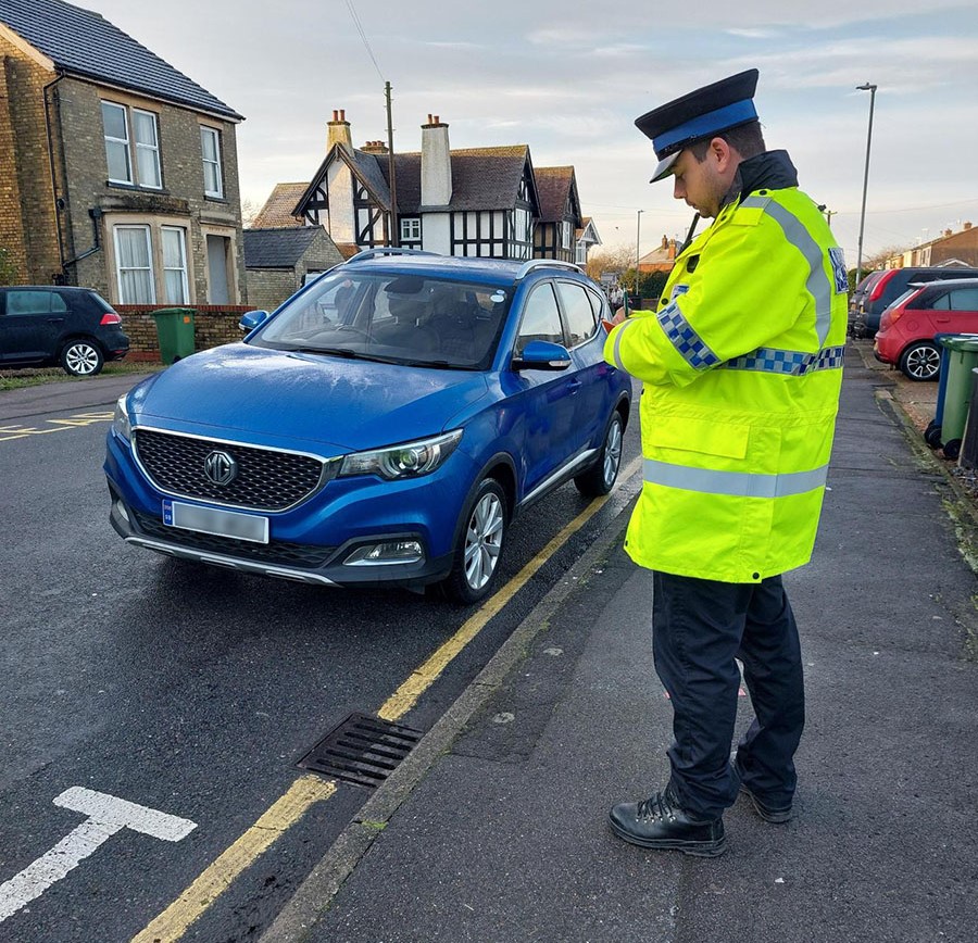 Police officers issue parking tickets during a targeted enforcement operation in Ely, highlighting the continued reliance on limited police resources in the absence of civil parking enforcement across East Cambridgeshire. PHOTO: Policing East Cambridgeshire