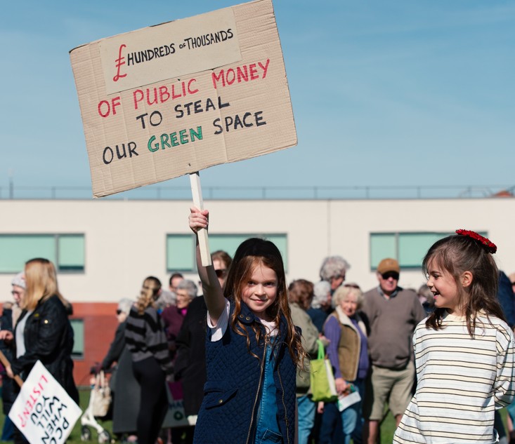 Supporters of the Save Werrington Fields campaign gather in large numbers on Saturday, calling on Peterborough City Council to delay its decision and reopen transparent talks over the future of the community green space. PHOTO: John Wallis