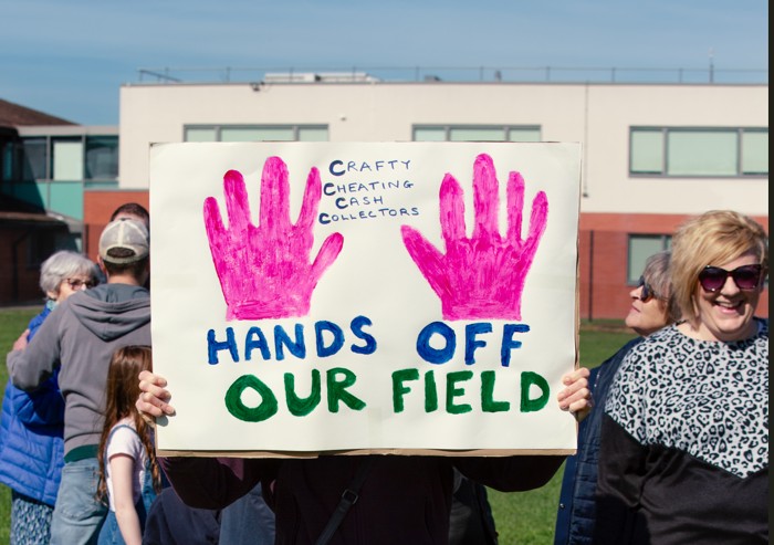 Supporters of the Save Werrington Fields campaign gather in large numbers on Saturday, calling on Peterborough City Council to delay its decision and reopen transparent talks over the future of the community green space. PHOTO: John Wallis