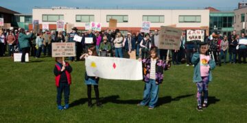 Supporters of the Save Werrington Fields campaign gather in large numbers on Saturday, calling on Peterborough City Council to delay its decision and reopen transparent talks over the future of the community green space. PHOTO: John Wallis