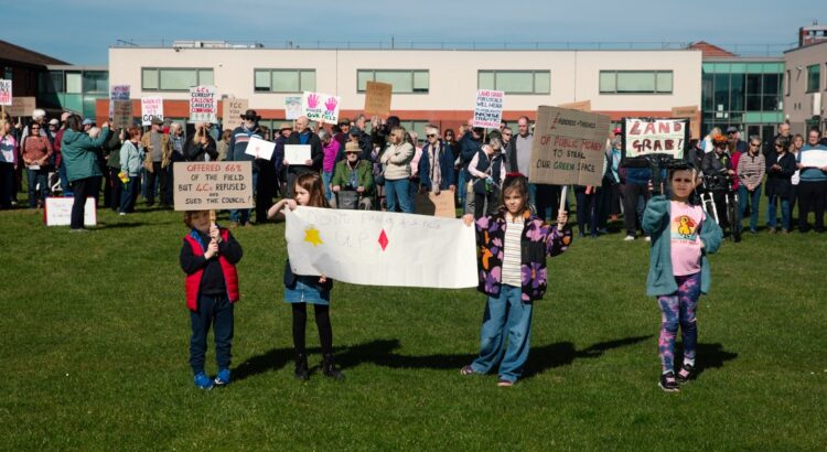 Supporters of the Save Werrington Fields campaign gather in large numbers on Saturday, calling on Peterborough City Council to delay its decision and reopen transparent talks over the future of the community green space. PHOTO: John Wallis