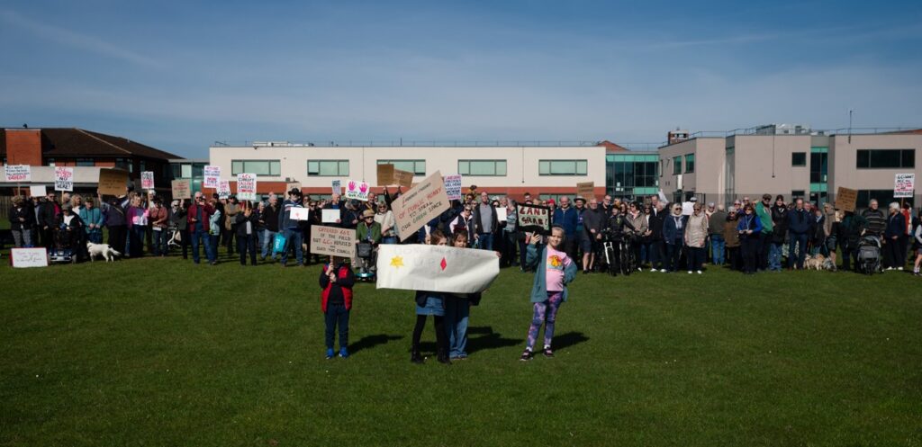 Supporters of the Save Werrington Fields campaign gather in large numbers on Saturday, calling on Peterborough City Council to delay its decision and reopen transparent talks over the future of the community green space. PHOTO: Paul Saunders