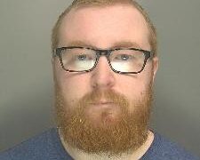 Custody image of Ben Sharpe, 31, who has been jailed for child abuse image offences and breaching a Sexual Harm Prevention Order.