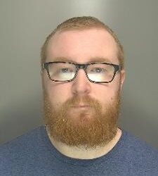 Custody image of Ben Sharpe, 31, who has been jailed for child abuse image offences and breaching a Sexual Harm Prevention Order.