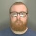 Custody image of Ben Sharpe, 31, who has been jailed for child abuse image offences and breaching a Sexual Harm Prevention Order.
