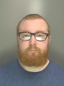 Custody image of Ben Sharpe, 31, who has been jailed for child abuse image offences and breaching a Sexual Harm Prevention Order.