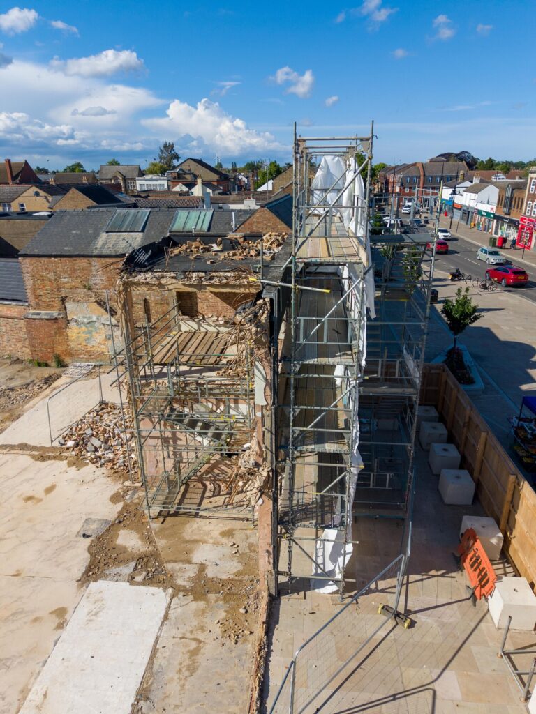 Exposed masonry and structural supports remain visible at the former Barclays Bank site in March as engineers grapple with unforeseen demolition complications. Photo: Terry Harris/CambsNews