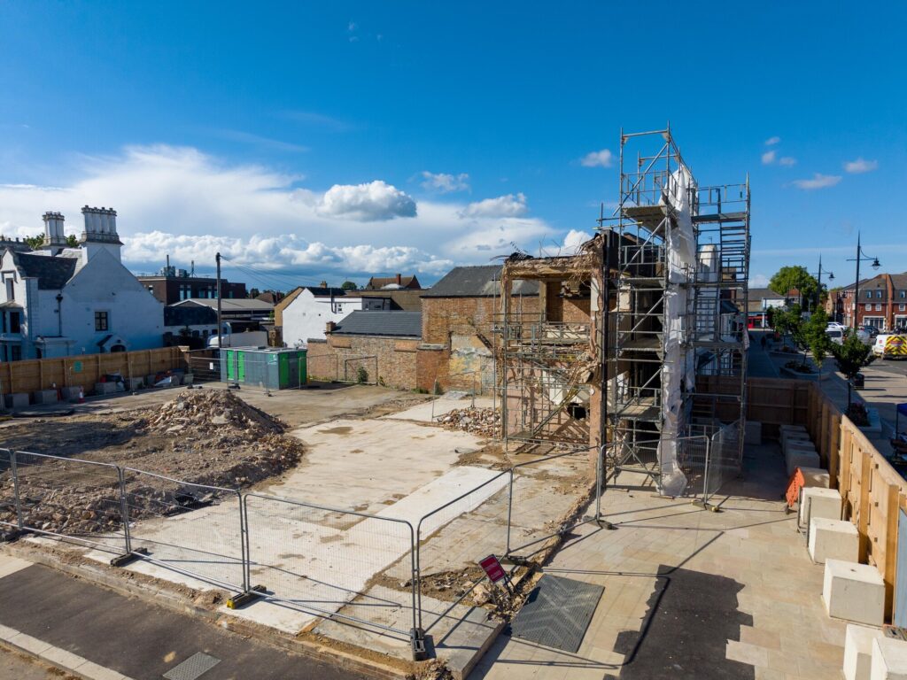 The partially demolished former Barclays Bank building remains fenced off in Broad Street amid ongoing party wall issues which have halted full clearance of the site. Photo: Terry Harris/CambsNews