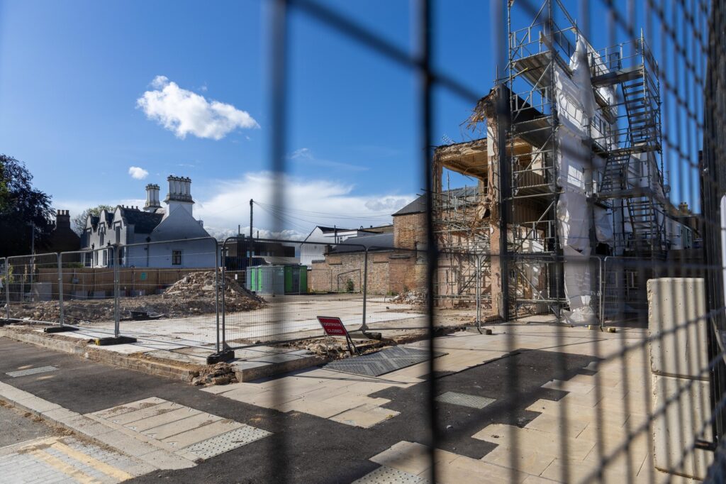 The partially demolished former Barclays Bank building remains fenced off in Broad Street amid ongoing party wall issues which have halted full clearance of the site. Photo: Terry Harris/CambsNews